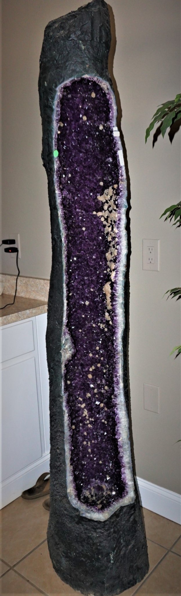 Purple And Black Stone Decor In A Beige Room With Green Leaves Showing