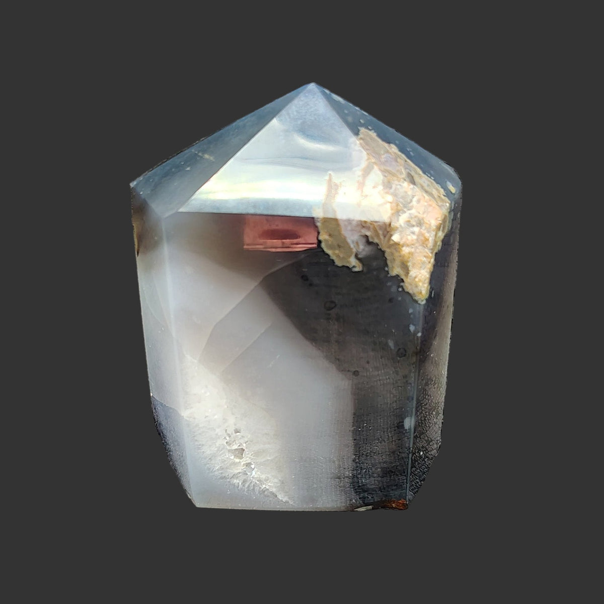 This is the back side of this aura coated crystal point.