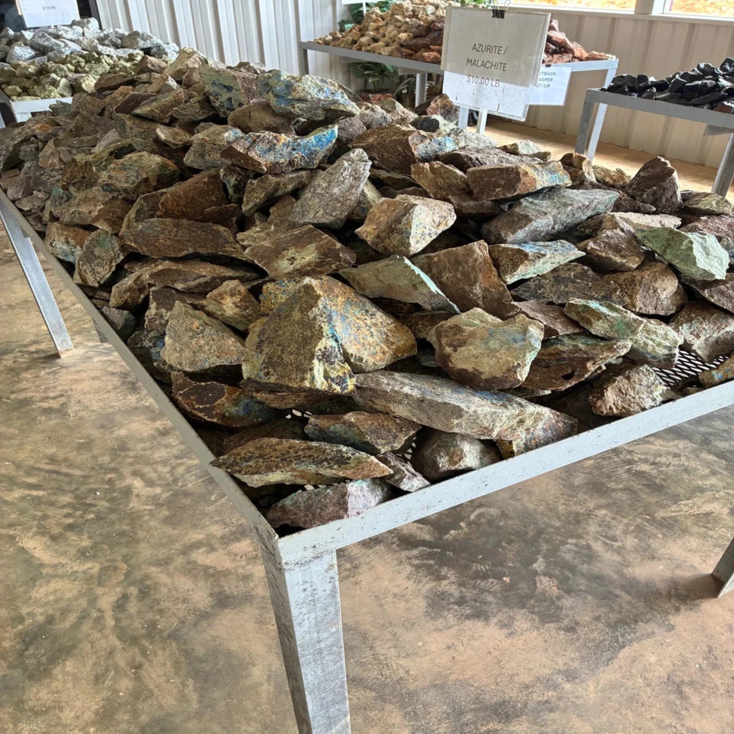 Side view of raw Azurite Malachite on a table outdoors.