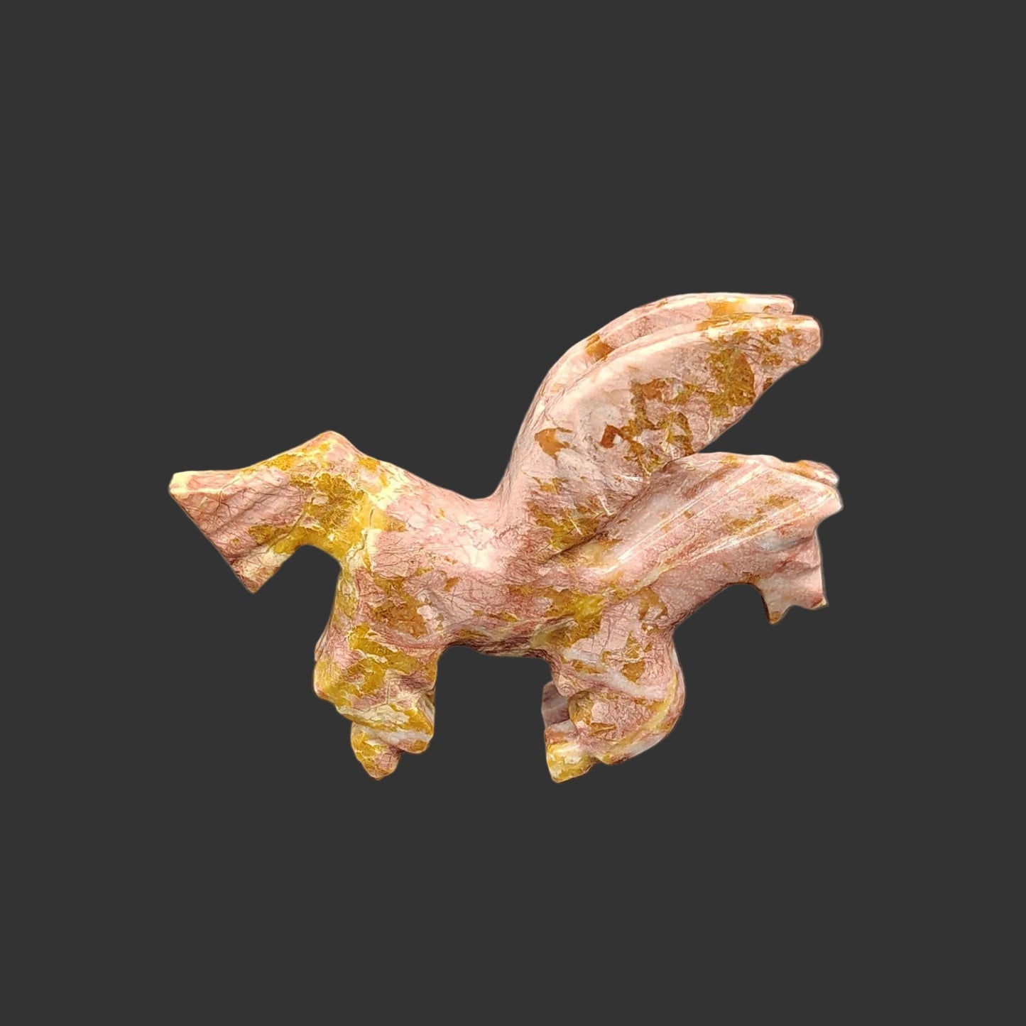 This is the right side of this hand carved strawberry and brown Onyx Pegasus horse kneeling down.