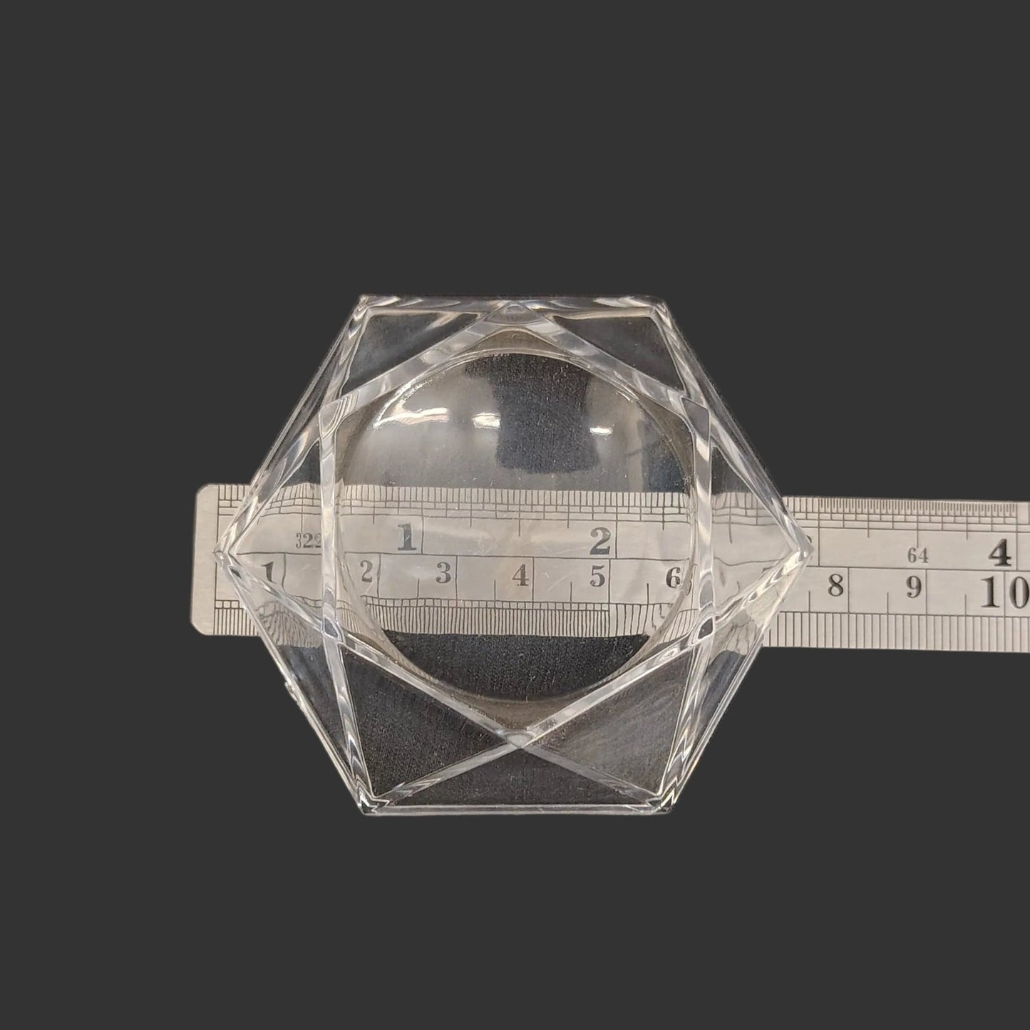 This hexagon shaped acrylic stand is 3 inches in diameter.
