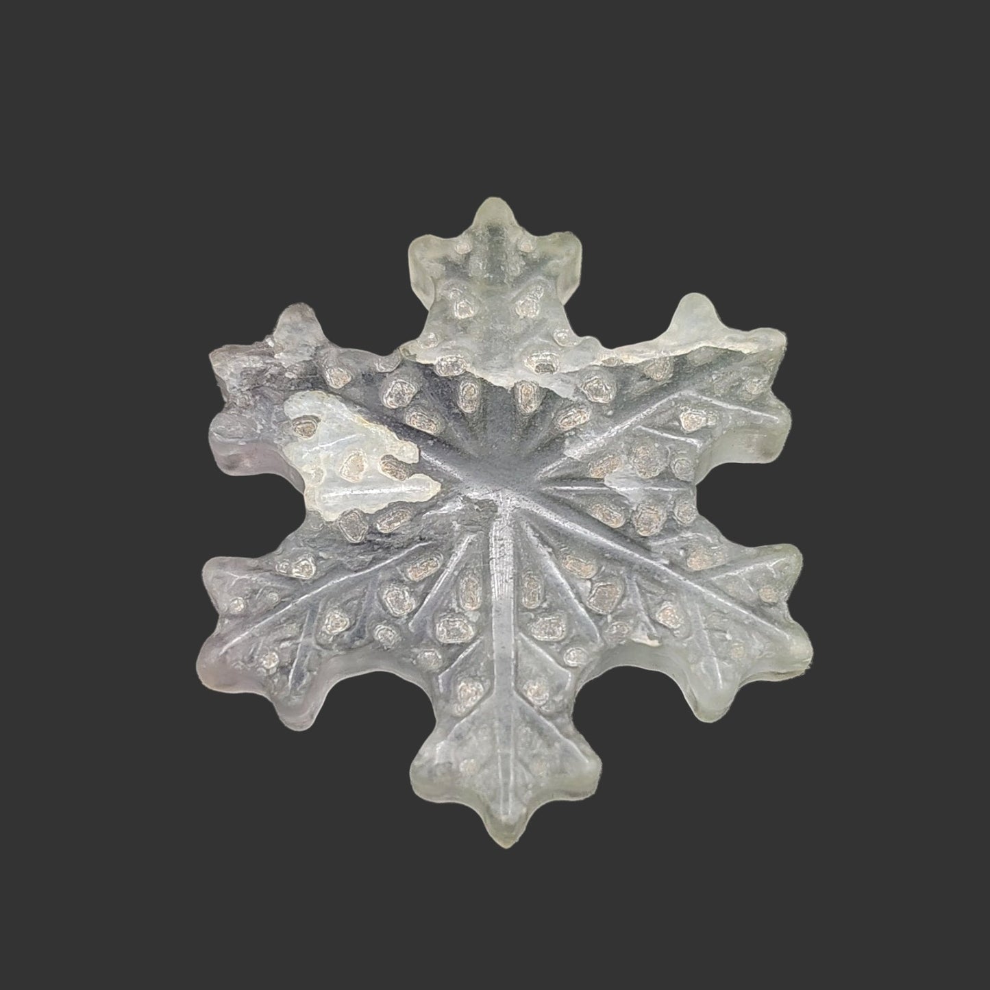 This is the face of this light green fluorite snowflake.