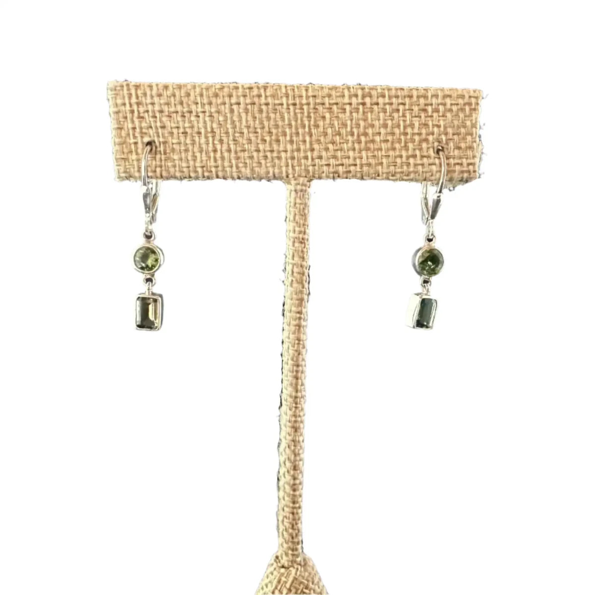 Multi Shape Peridot Dangle Earrings On A Display Stand