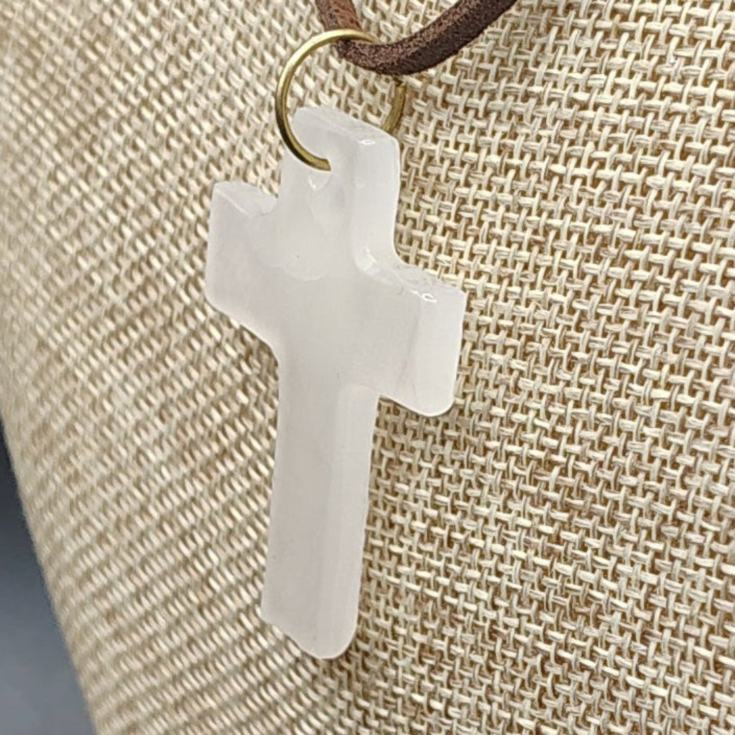 This is a close up of the polished cream-colored Onyx cross pendant.