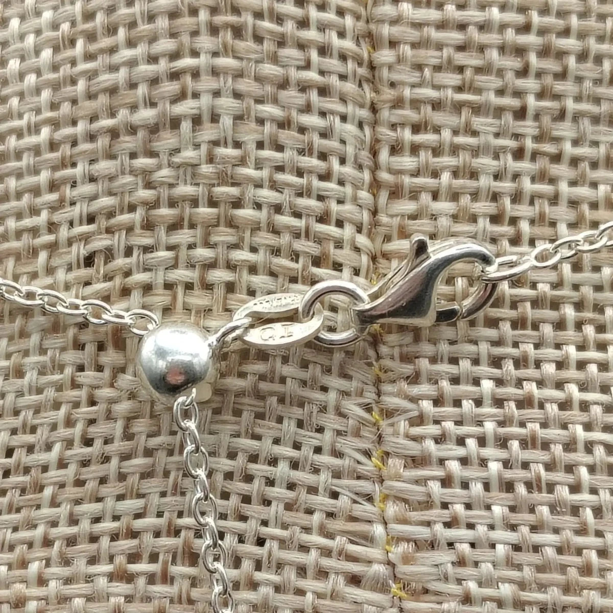 This is a close up of the sterling silver lobster claw clasp on this adjustable necklace.