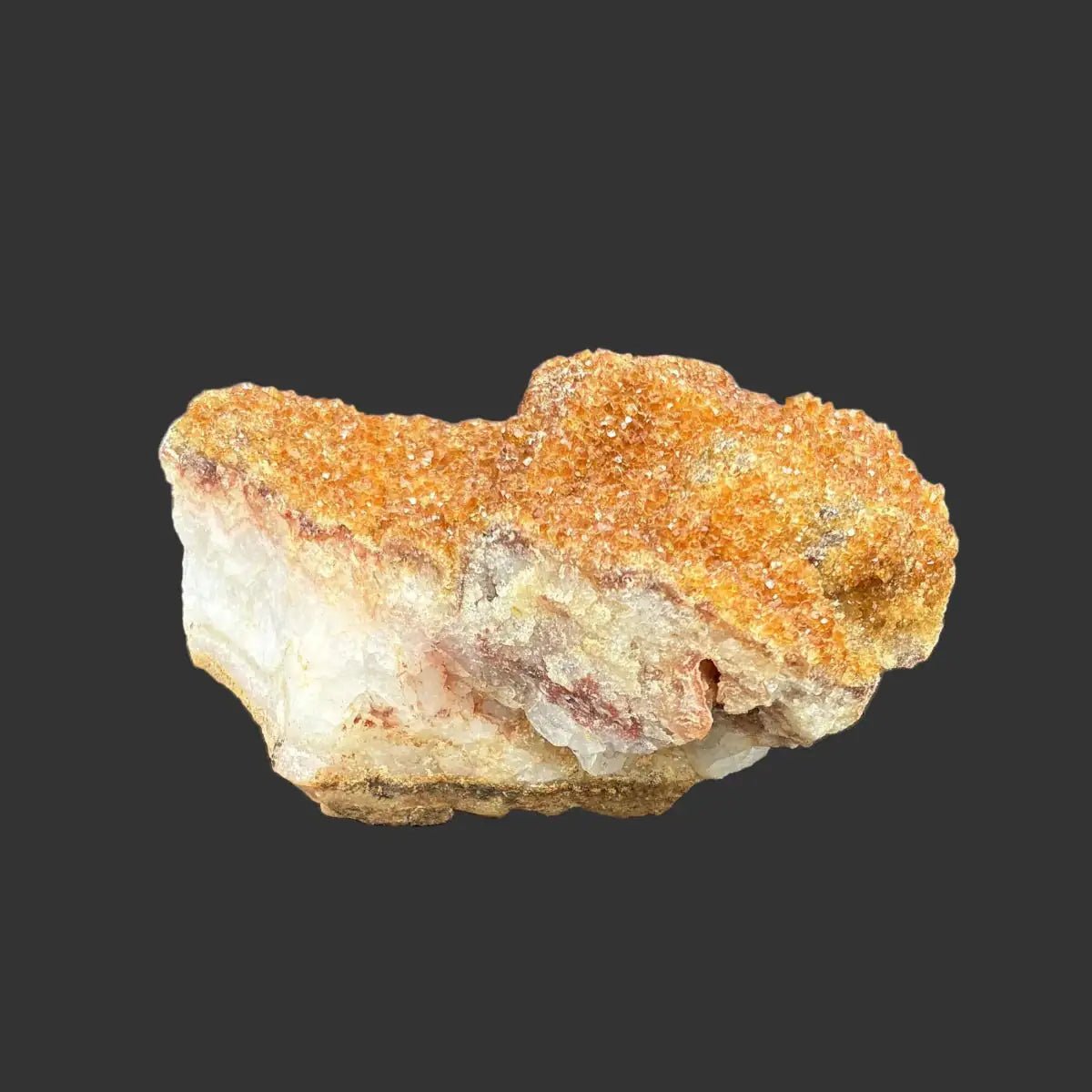 Back side of this Citrine specimen in front of a black background.