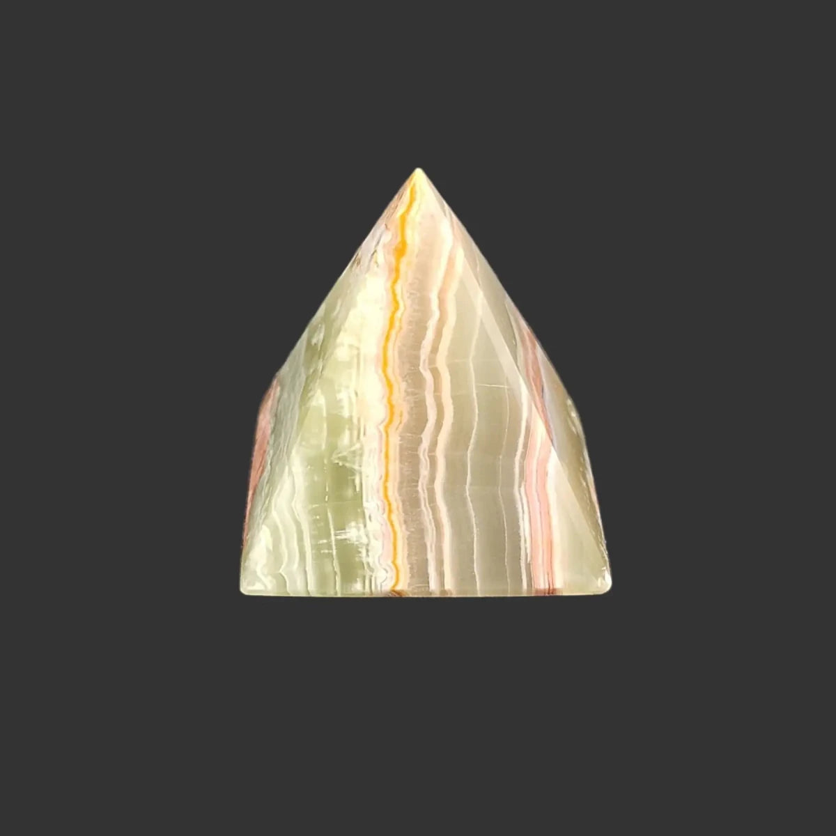 The left side of this green onyx pyramid is covered in bilateral lines of green, orange, and cream.