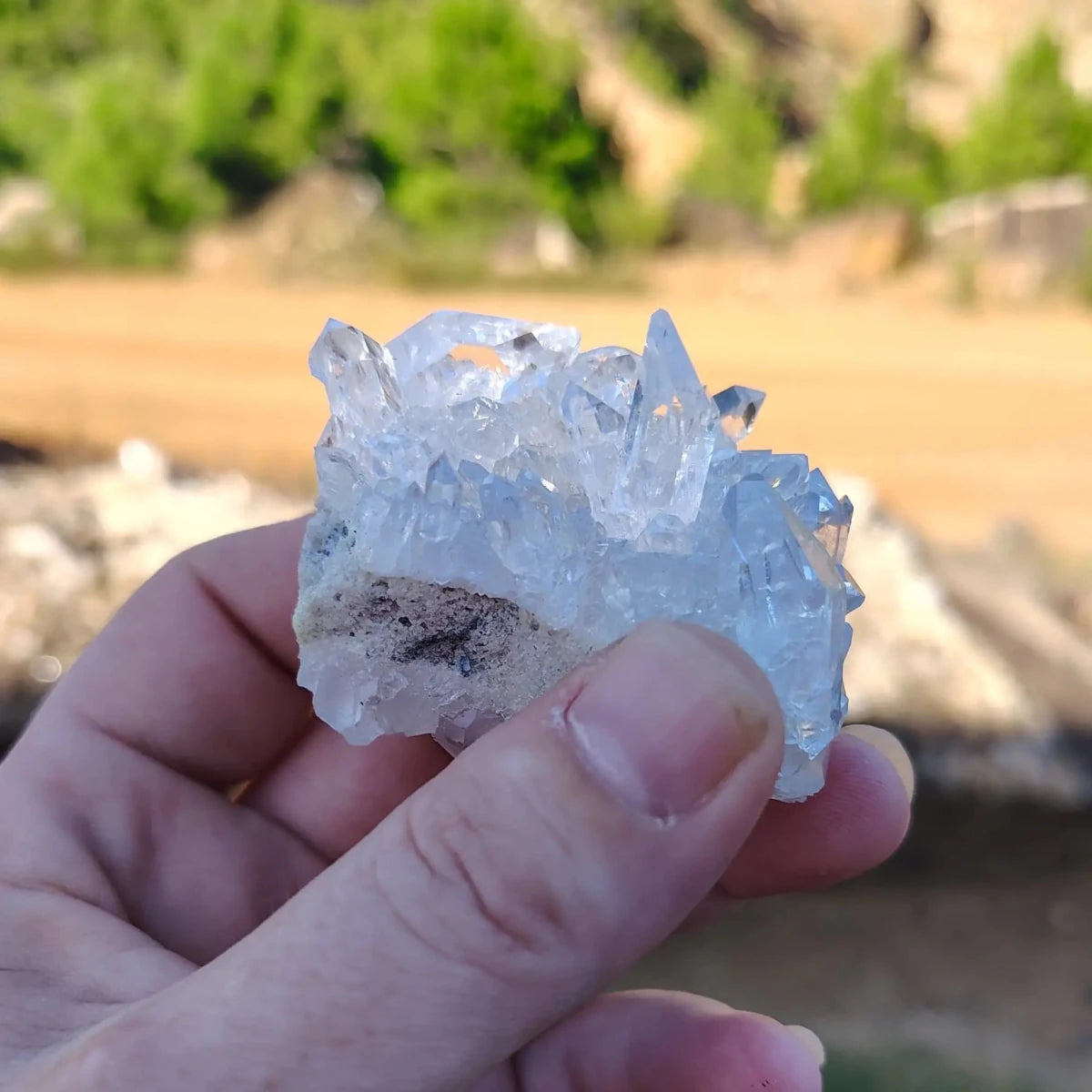 This picture displays that this is a small palm sized quartz crystal cluster