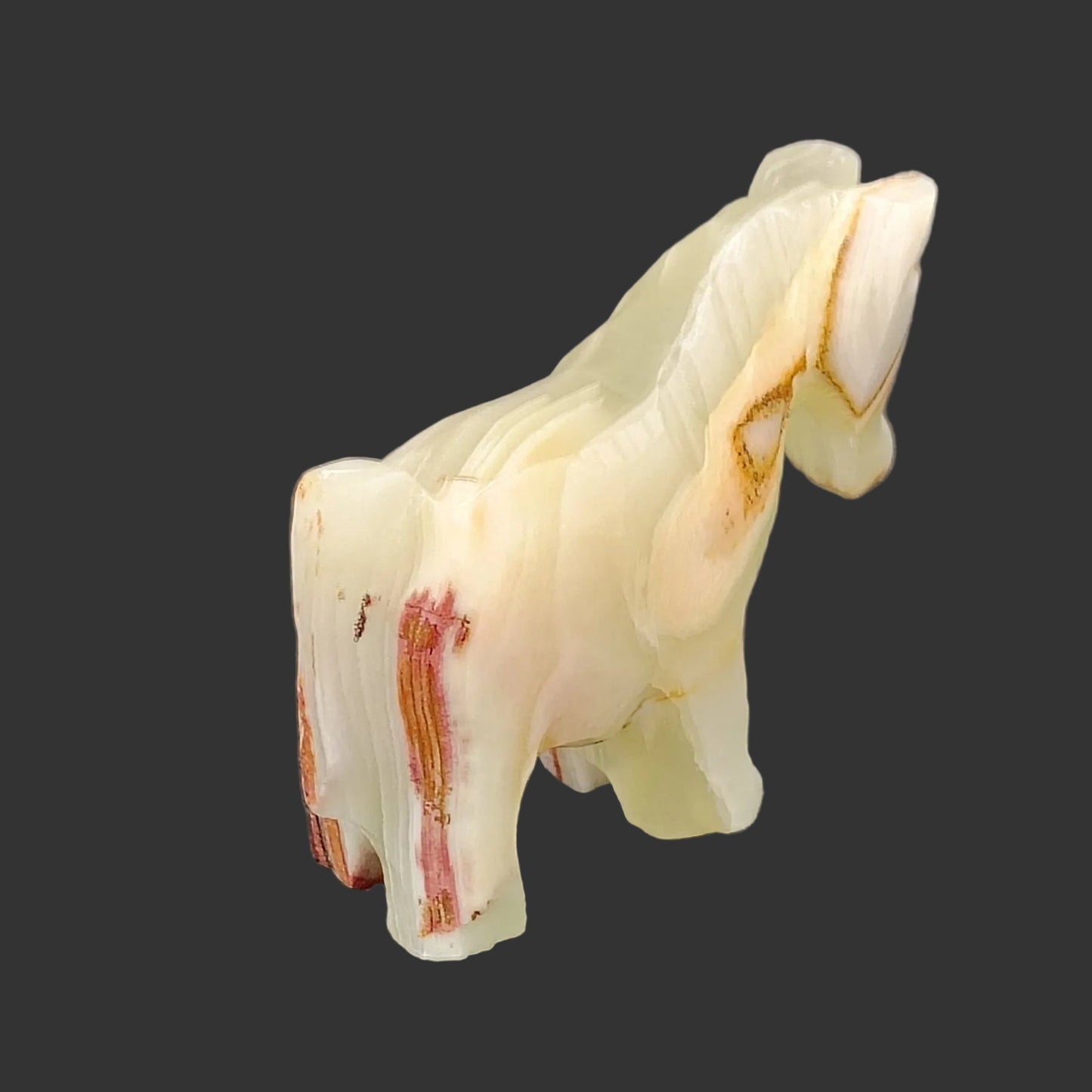 This is the back side of this polished horse figurine, and its mostly cream in color.