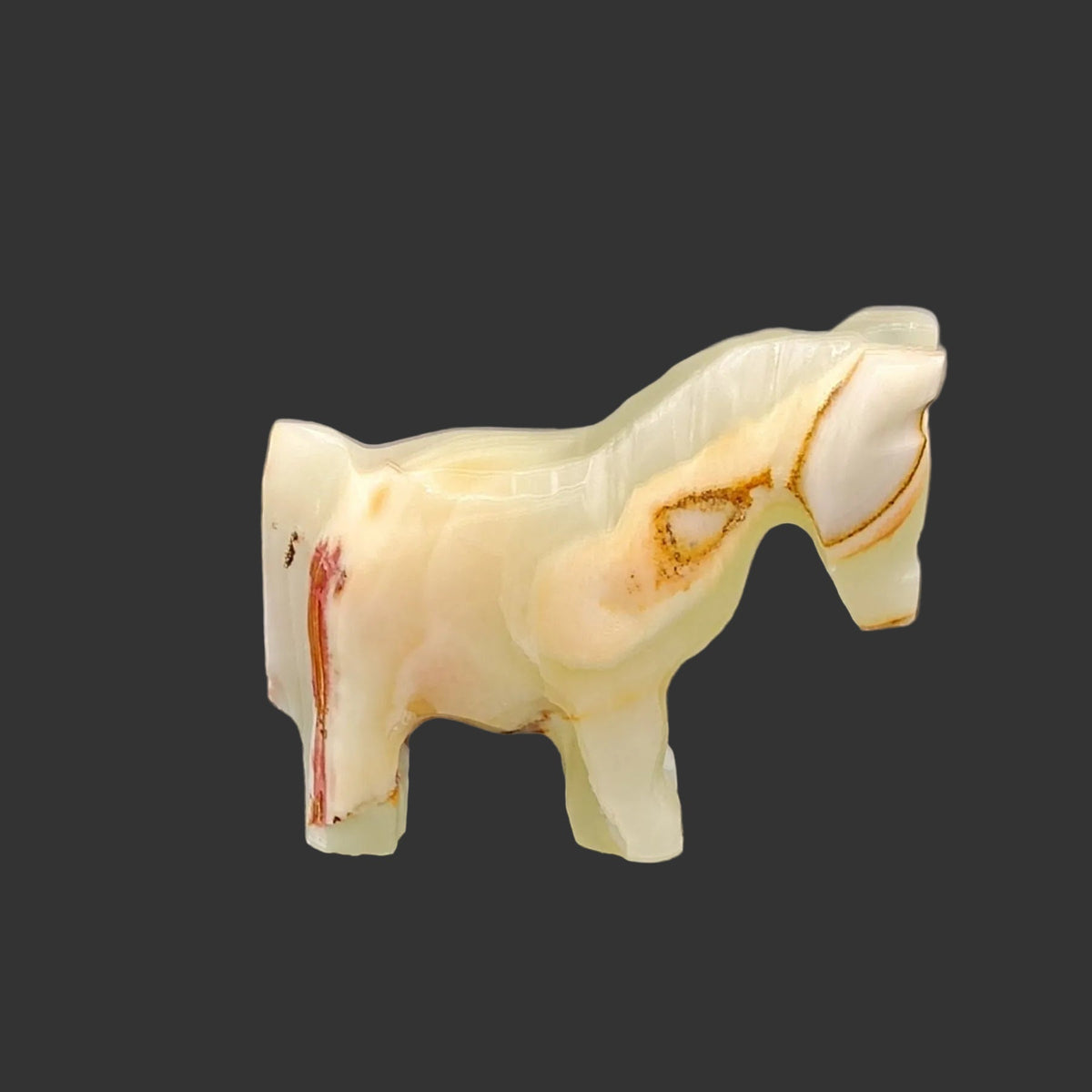 The right side of this polished horse figurine is mostly green, with some cinnamon, cream, and brown.