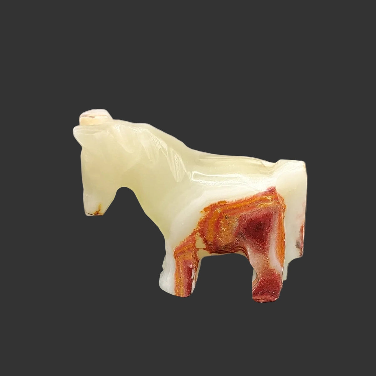 The left side of this horse figurine is cream and cinnamon in color.