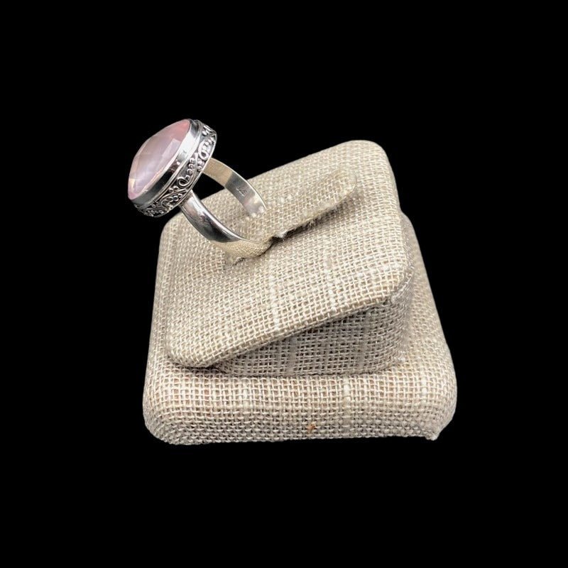 Side View Silver Oval Rose Quartz Gemstone Ring, and all Around The Gemstone Is A Paisley Pattern In The Sterling Silver