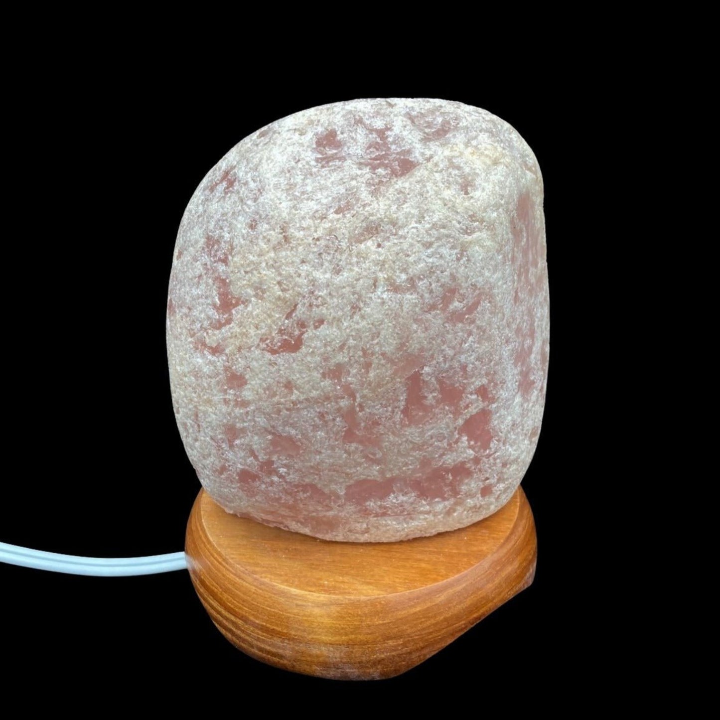 Rose Quartz Tumbled Lamp in front of a black background.