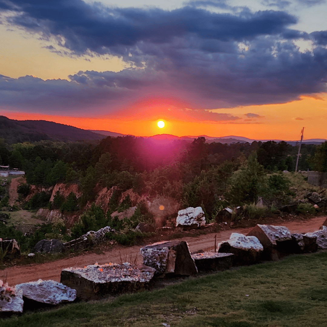 Sunset over a landscape with rocks and trees