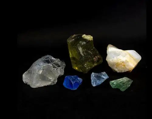 5 pieces of glass cullet on black background