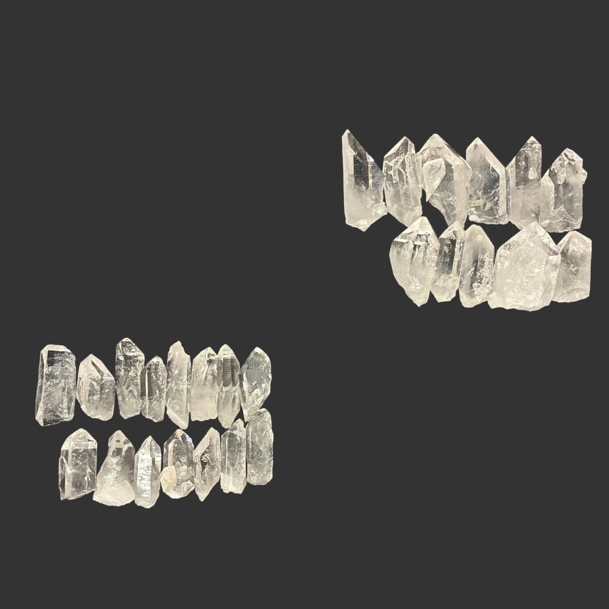 3 pounds of quartz crystal points on a black background.