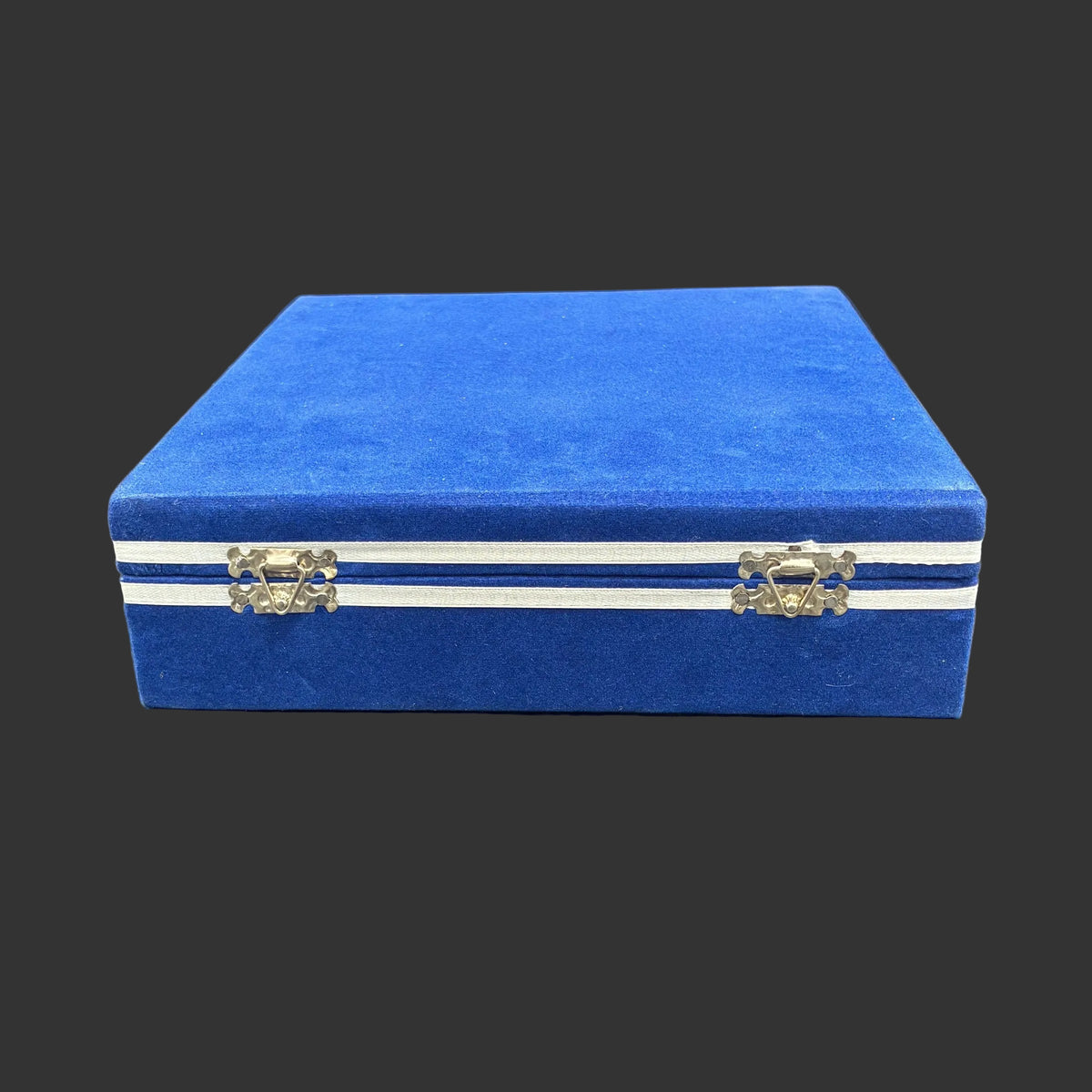 Blue velvet case that is included with the set of 6 sherry glasses, in front of a black background.