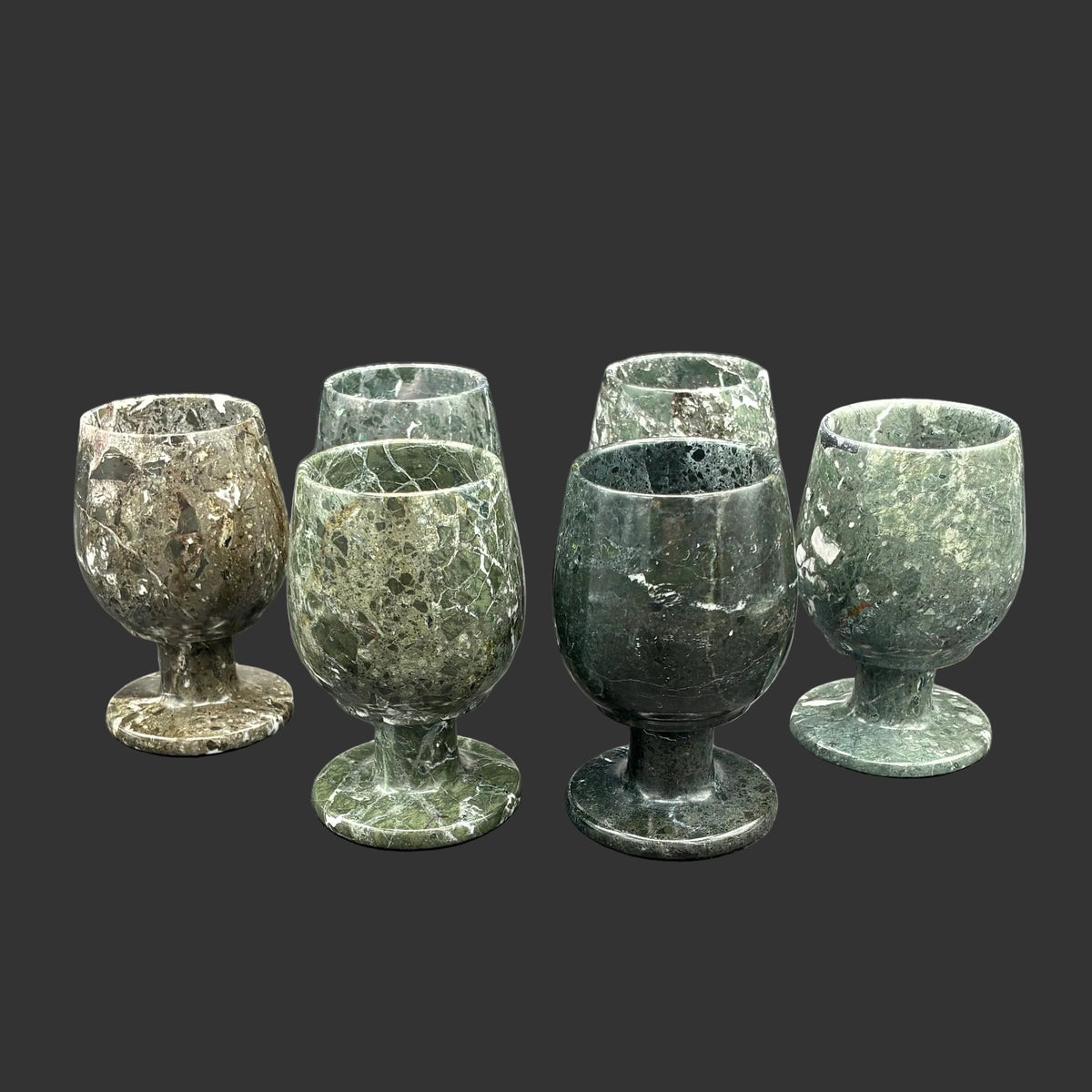 All 6 onyx sherry glasses, in front of a black background.