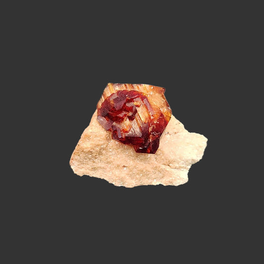 This is the front view of this Arcanite mineral specimen. The crystal formation is a reddish brown and the base is tan in color.