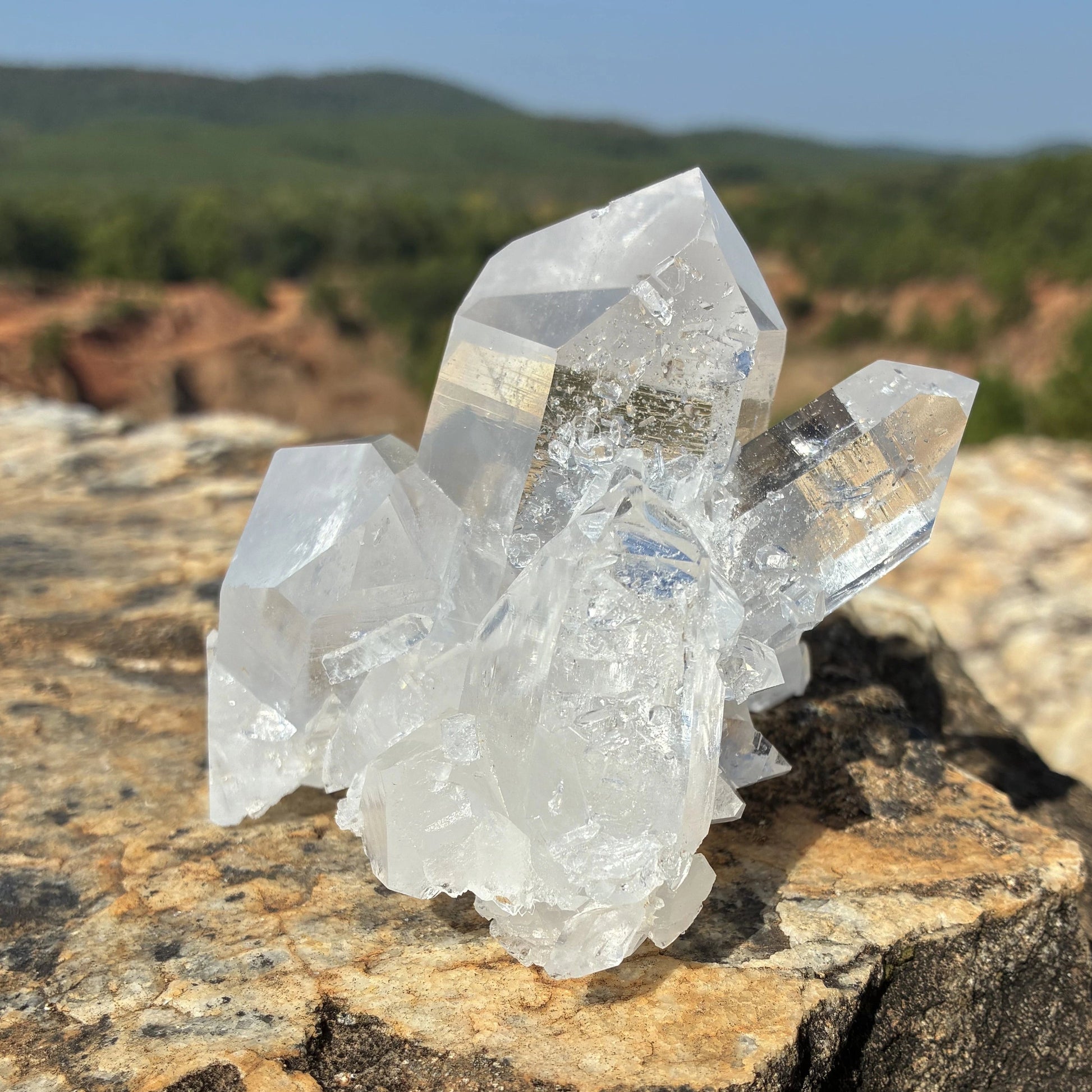 This is the right side of this quartz crystal cluster, on a rock outdoors.