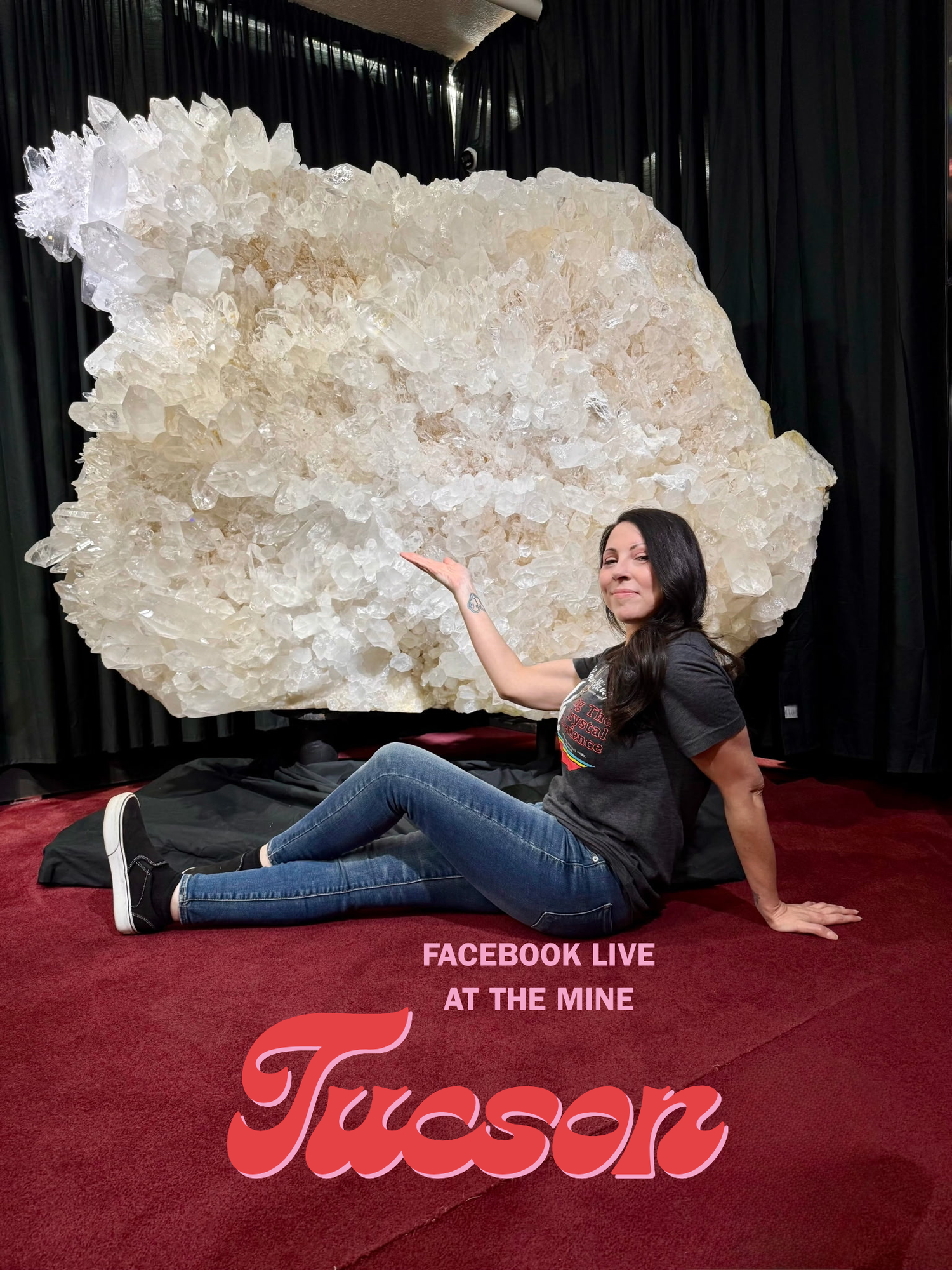 Person posing with a large crystal formation at an event in Tucson.