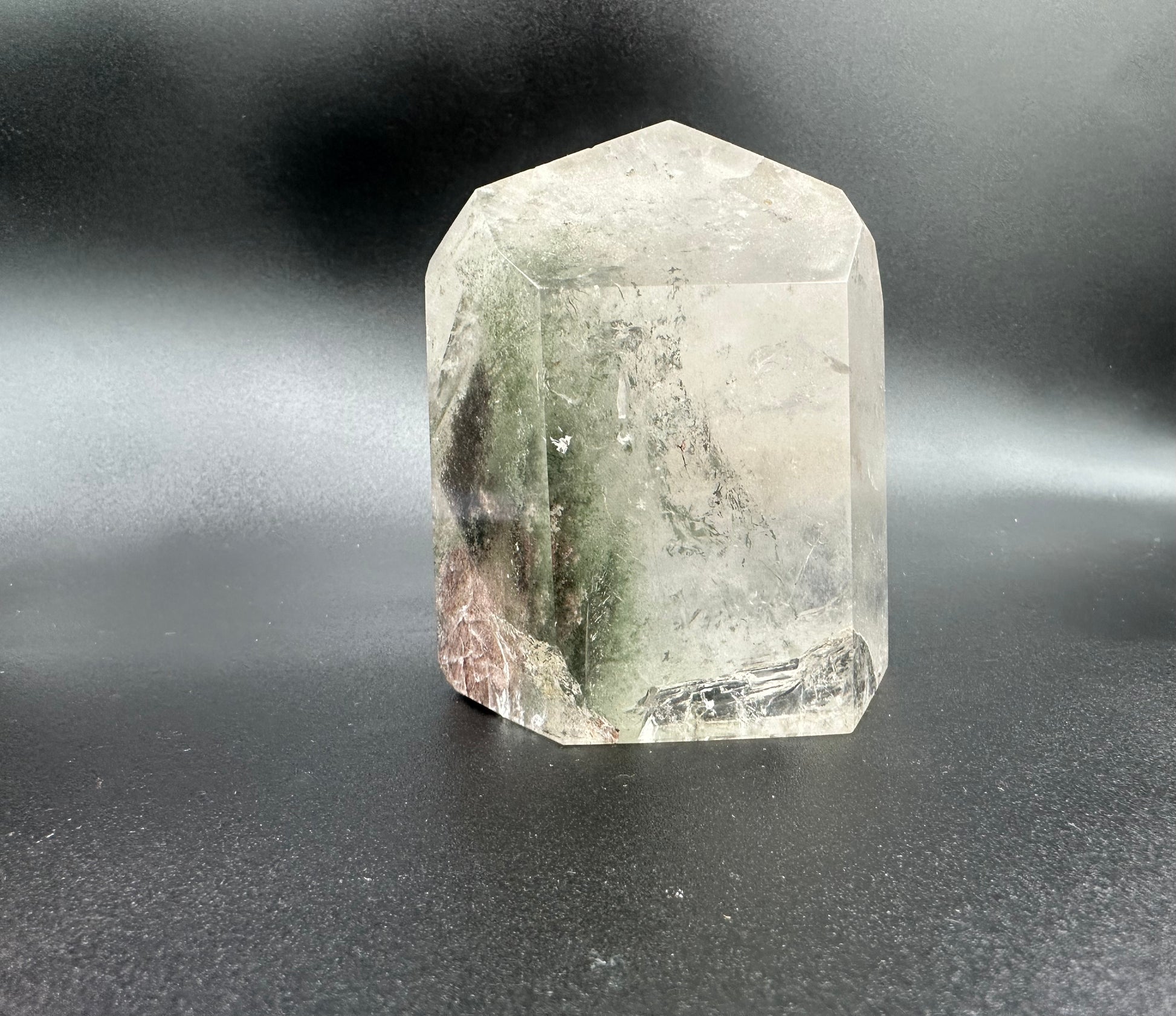 Back View Of Chlorite Included Quartz Showing Green Chlorite Within The Mineral.  The bottom is showing a slight fracture within the mineral