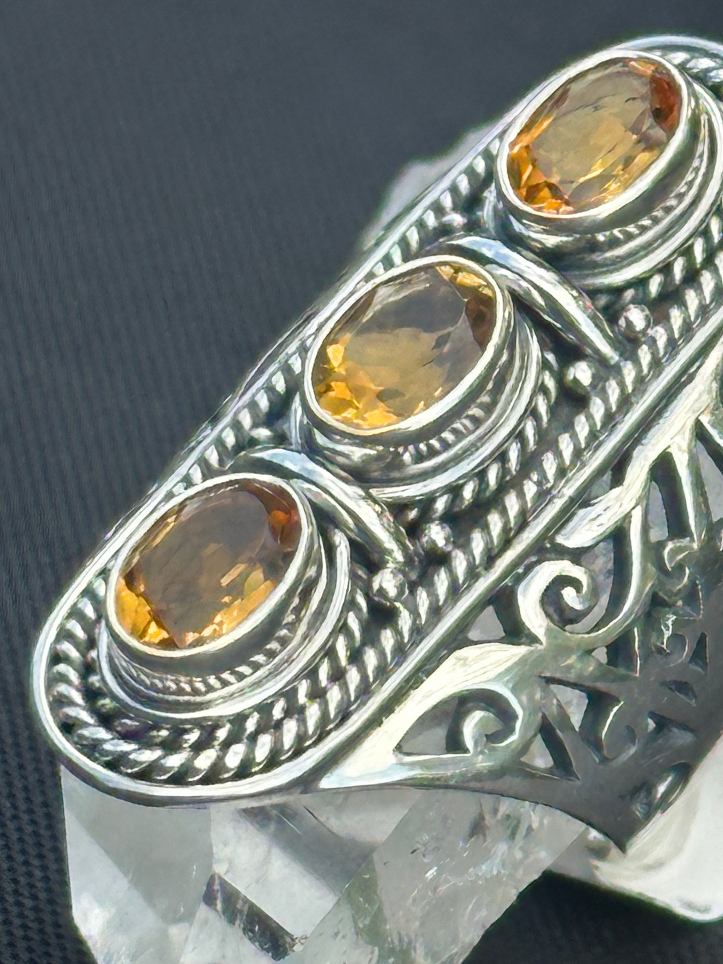 Close Up View Of 3 Ctrine Stone Ring With Rope Design Bezels And Top Open Design Sides