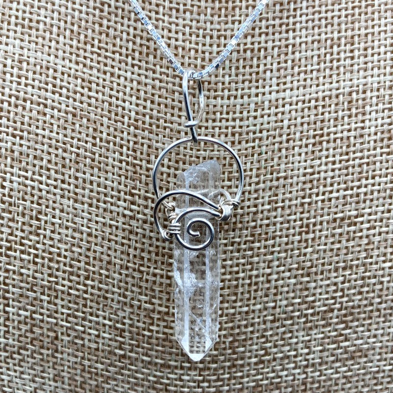 Close Up Of Sterling Silver Wire Wrapped Crystal Point Pendant, Quartz Is Water CLear