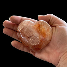 Load image into Gallery viewer, Hematoid Quartz Red Heart Crystal In Outdoor Natural Light, Polished And Marbled Clear Red And Orange
