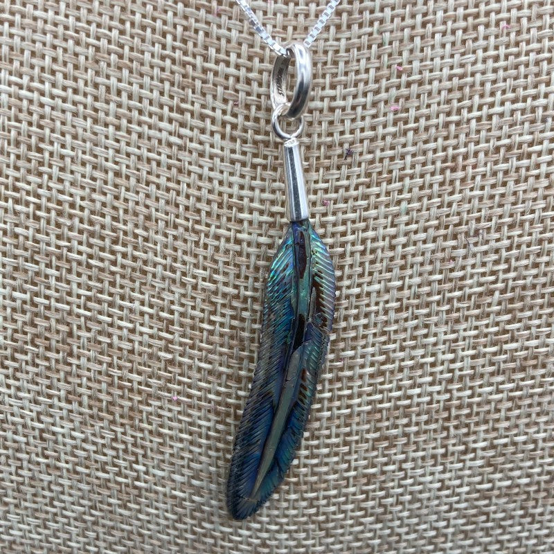 Close Up Of Abalone Shell Feather Pendant, Is Iridescent Blue And Green 
