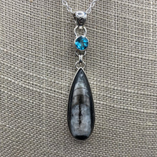 Load image into Gallery viewer, Close Up Of Orthoceras And Blue Topaz Pendants, Black Grey And Blue In Color
