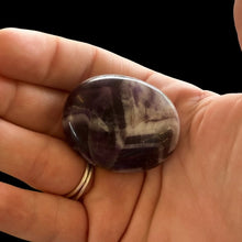 Load image into Gallery viewer, Small Polished Purple And White Zig-Zagged Pattern Chevron Amethyst Palm Stone In Natural Light

