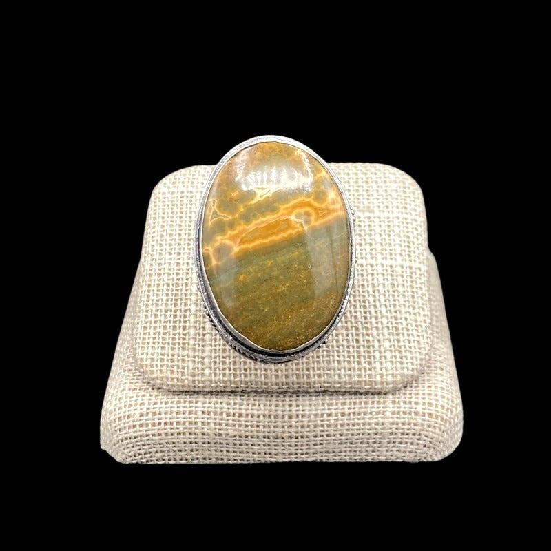 Front View Of Sterling Silver And Oval Shaped Ocean Jasper Gemstone Ring, Gemstone Is A Banding Of Bright Yellow And Olive Green