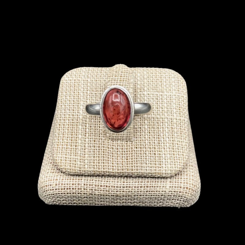 Front View Of Sterling Silver And Oval Shaped Tourmaline Gemstone Ring, Band Is Polished Silver And The Gemstobne Is A Shiny Pink Mauve