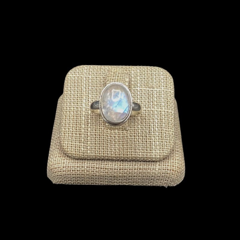 Front View Of Sterling Silver And Oval Cut Rainbow Moonstone Gemstone Ring, The Gemstone Is Oval Cut And Clear With A Iridescent  OverLay