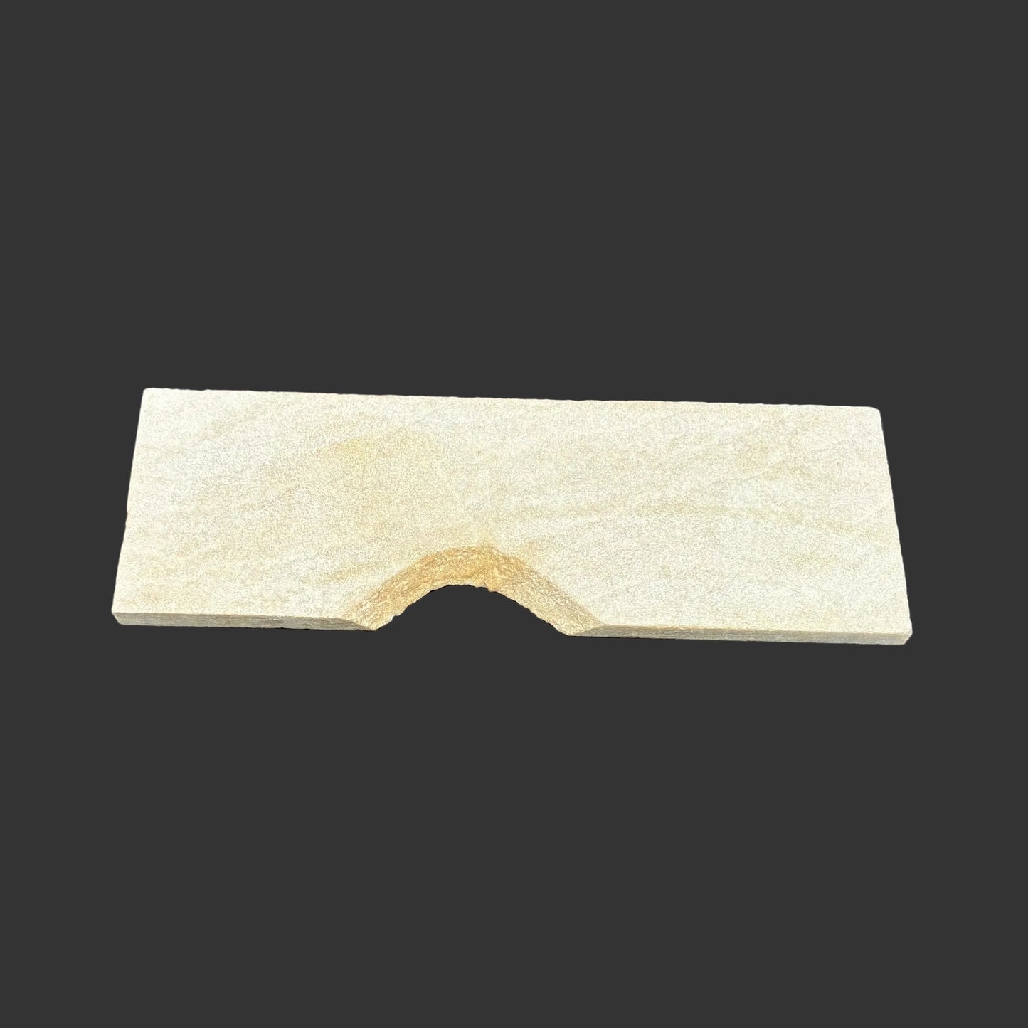 Front side of this novaculite sharpening stone, in front of a black background.
