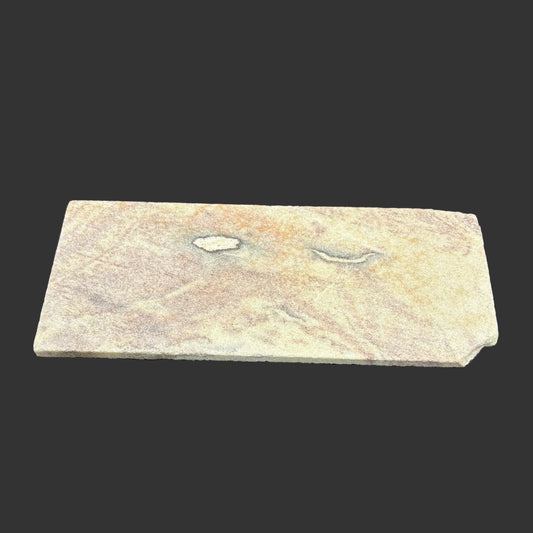 Front side of this novaculite sharpening stone in front of a black background.