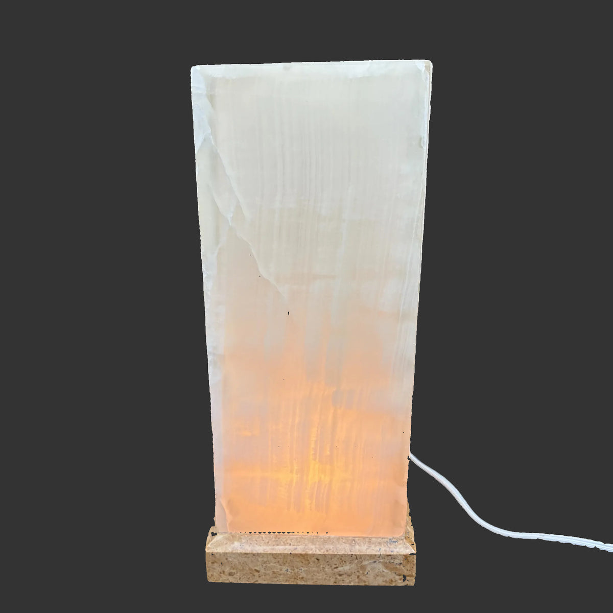 View of the lamp with the light turned on, in a dark room.