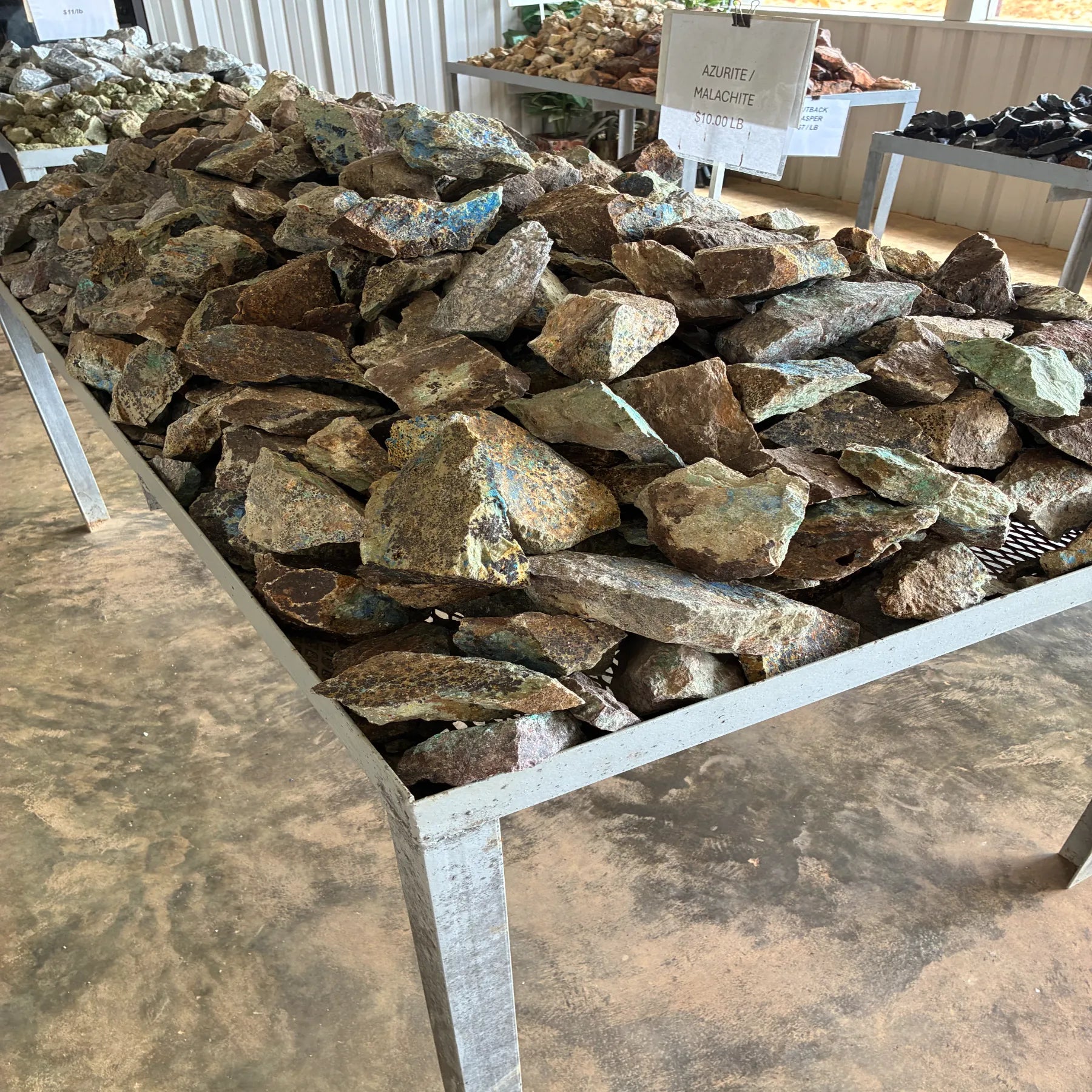 Side view of raw Azurite Malachite on a table outdoors.