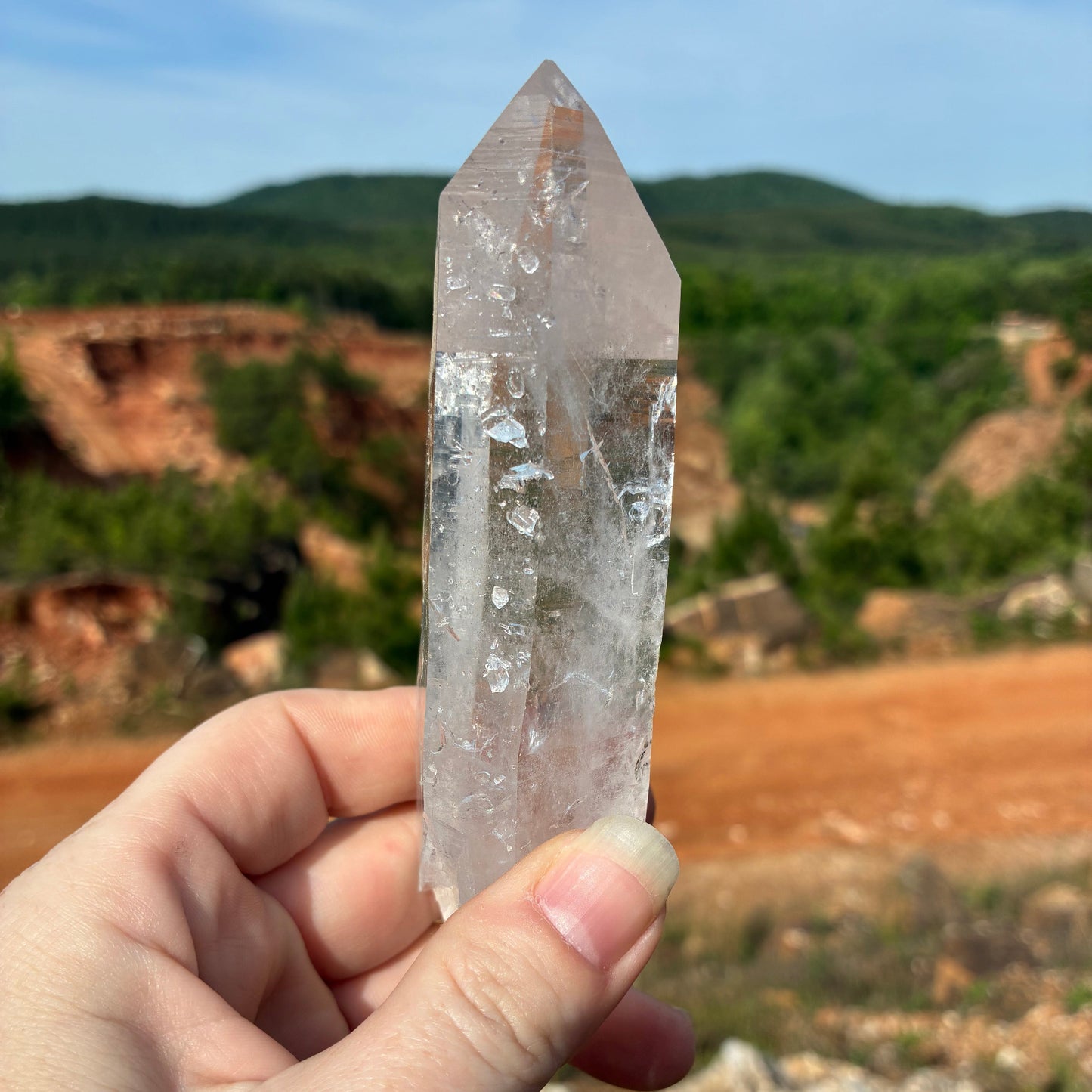 This is the back side of this single Quartz crystal point, outdoors in front of the mine.