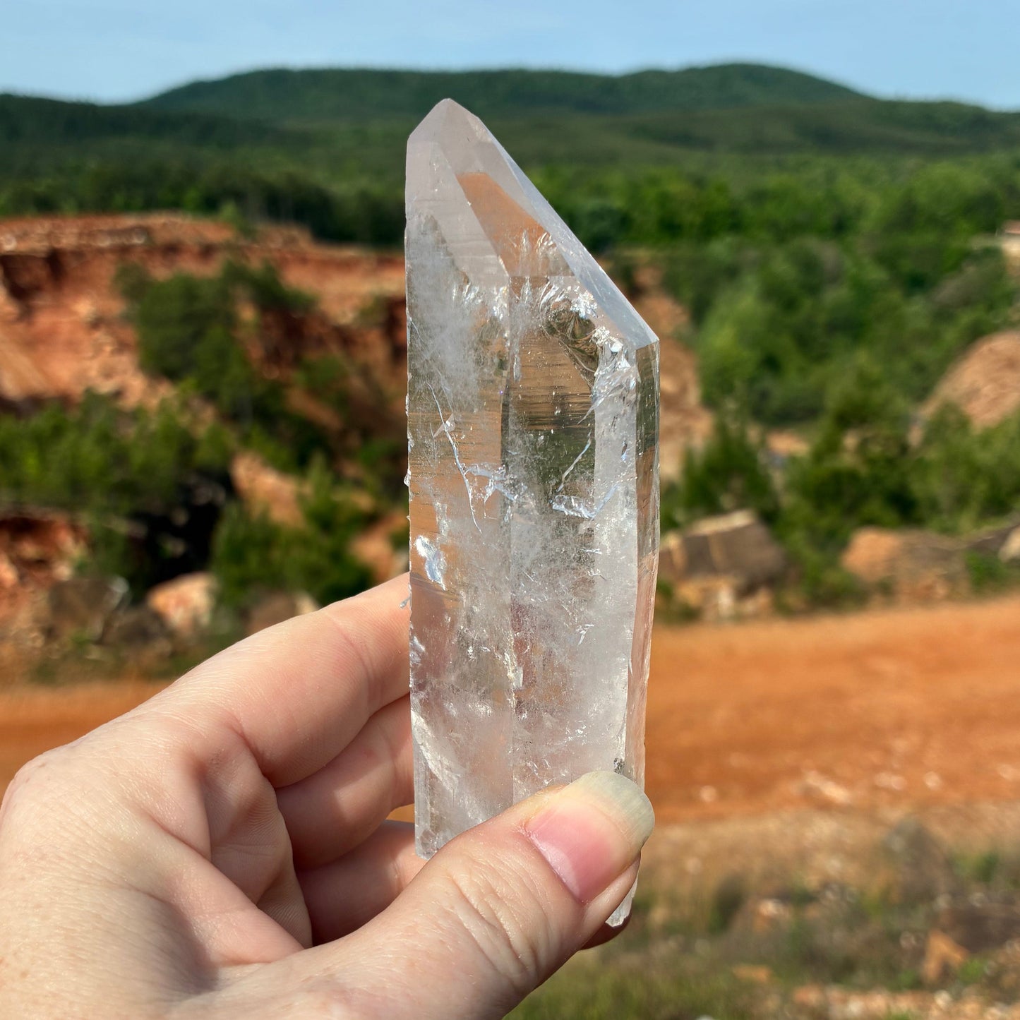 This is the right side of this single Quartz crystal point, outdoors in front of the mine.