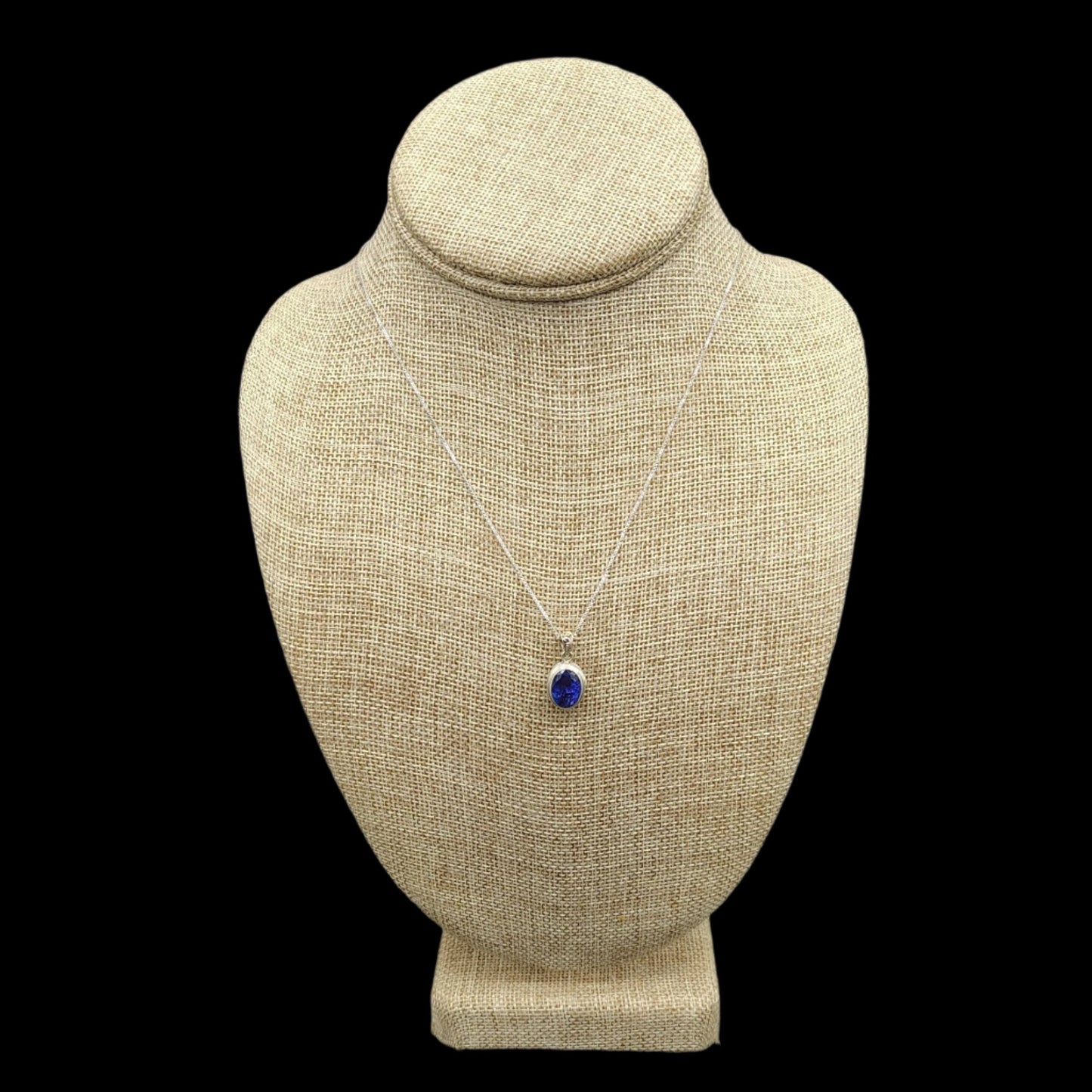 This is a Sterling Silver chain with a Sterling Silver and Tanzanite oval cut pendant