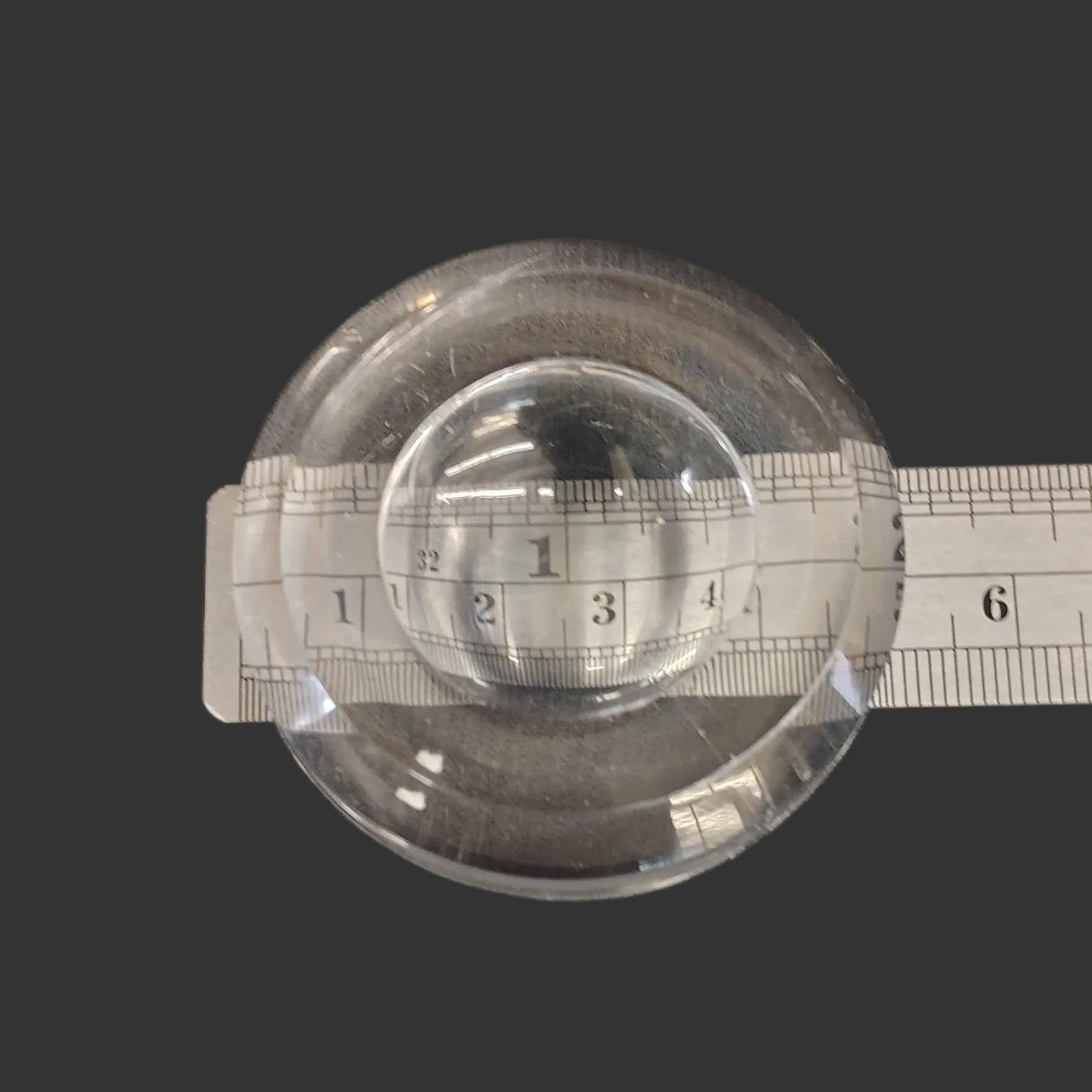 This acrylic display stand is 2 inches in diameter.