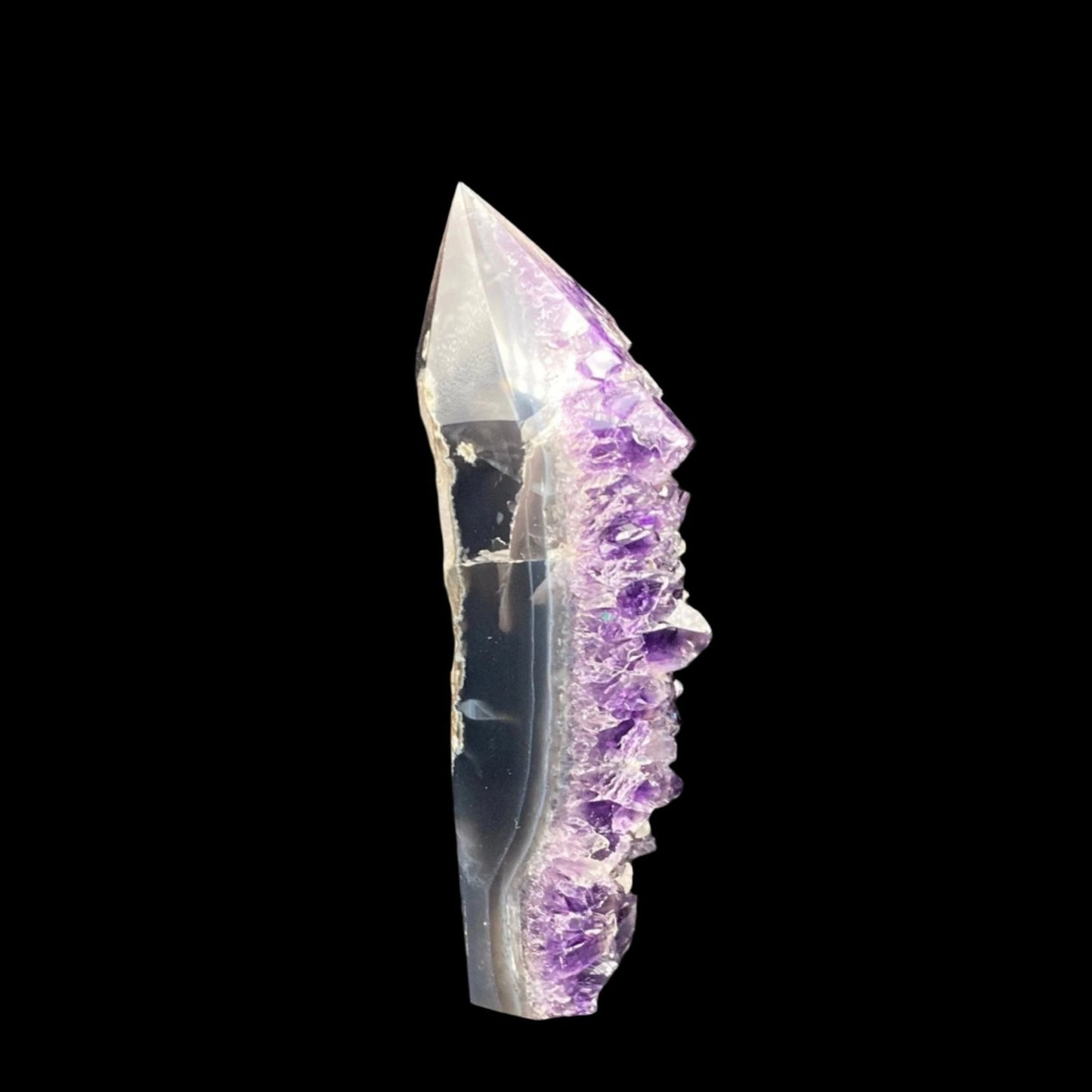 This is the right side of the Amethyst tower with Calcite. You can see the side of the crystals and the edge has been polished smooth.