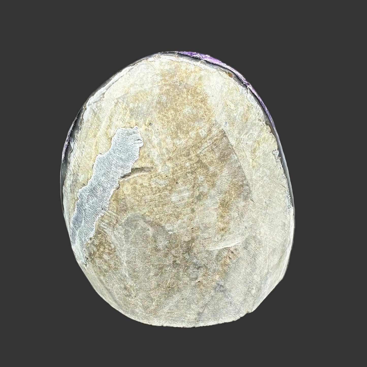 This is the back side of this Amethyst drusy cluster, and in front of a black background.