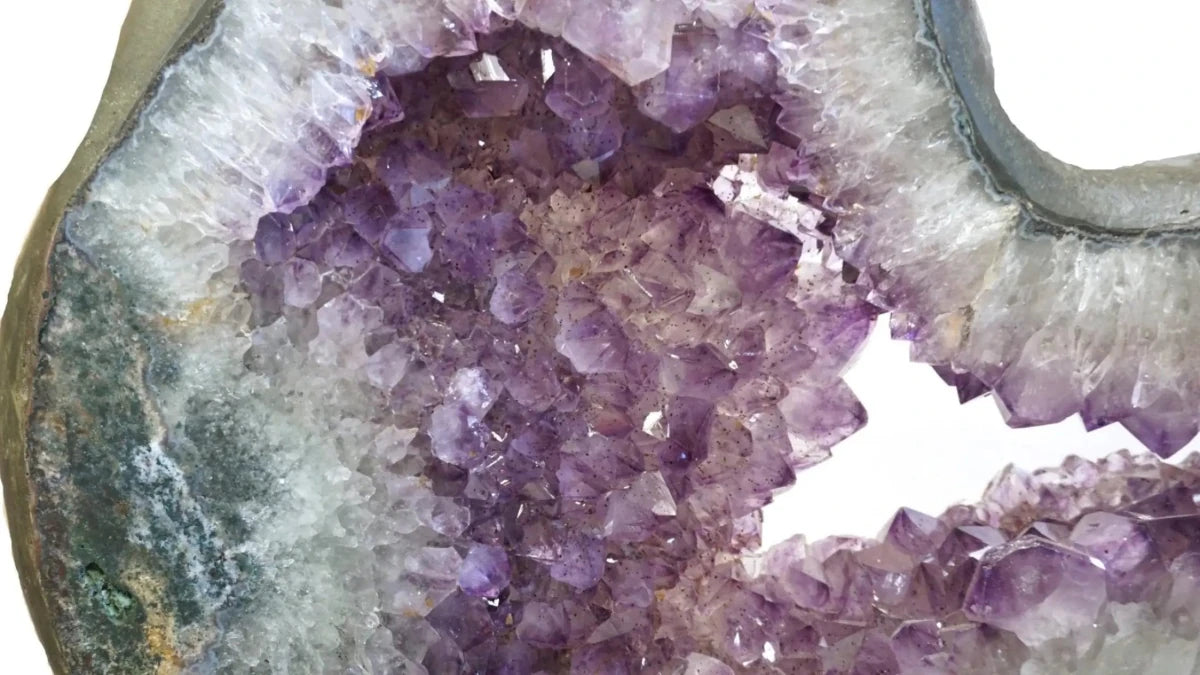 Close Up of Amethyst Crystal Clusters Within An Amethyst Geode Slice Carved Stone 360 Rotating Black Stand