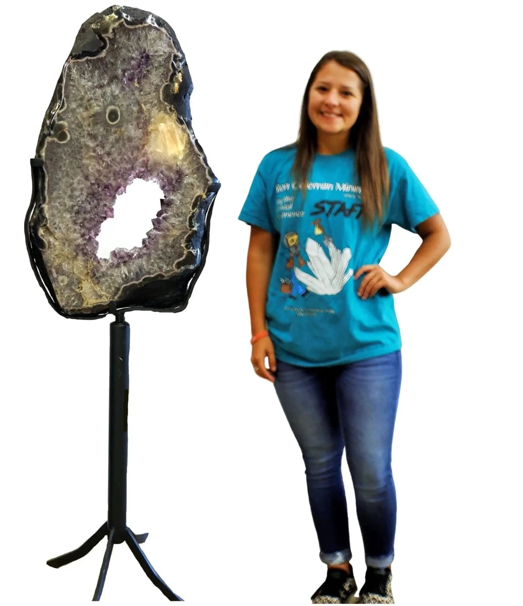 Amethyst Geode Slice On Rotating Stand with person standing beside it