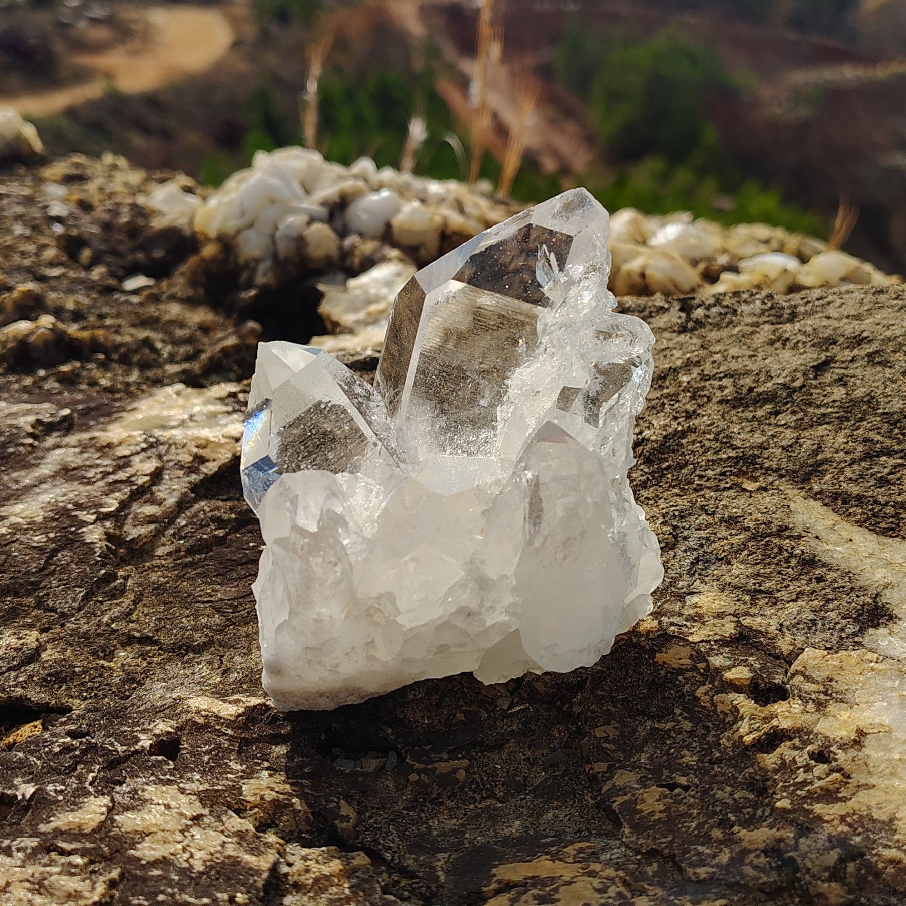 From the front view of this small quartz cluster you can see the biggest crystal point and a medium crystal point on both sides.