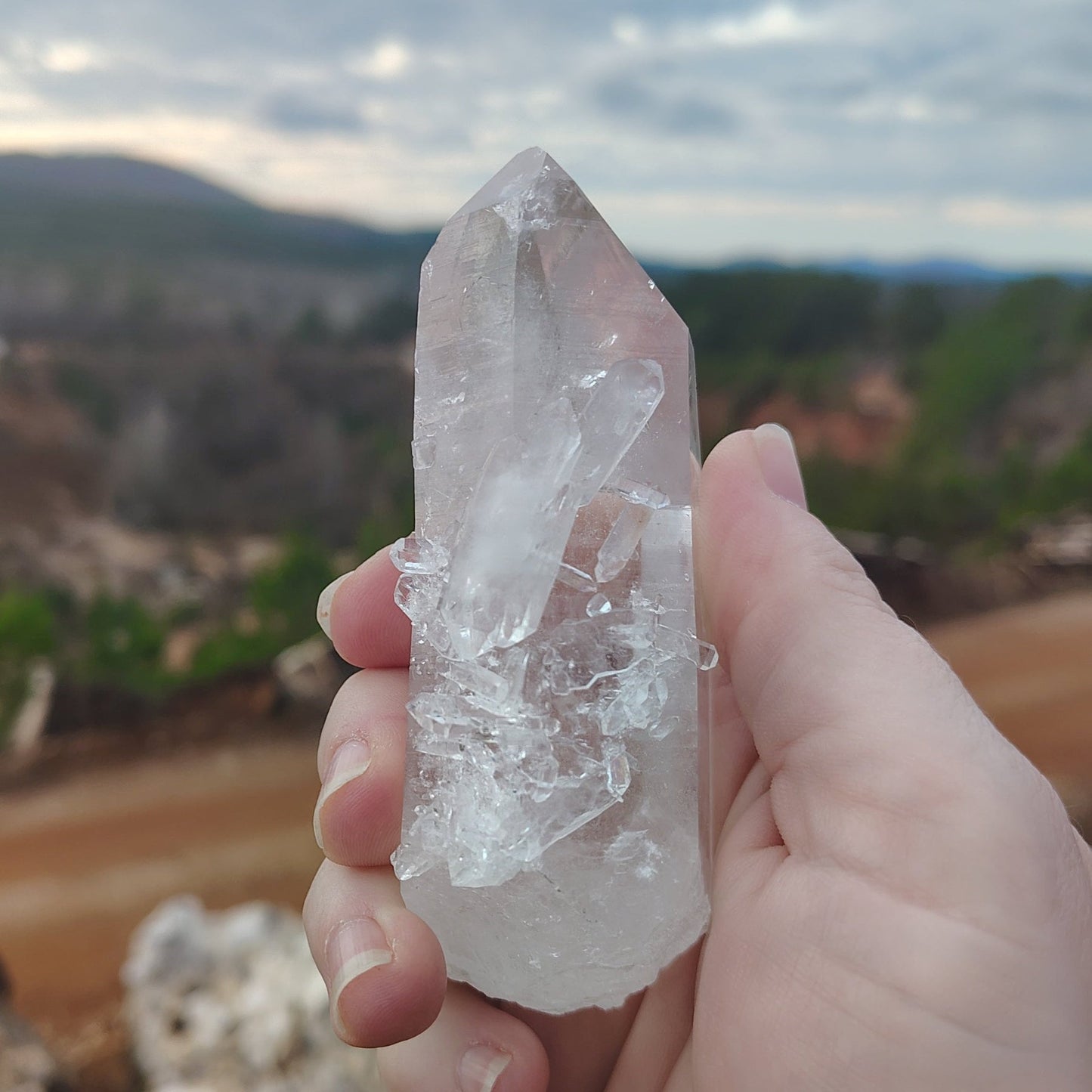 This is the front side of this Quartz crystal point. It has druzy crystals and a couple double terminated tabby's on it.