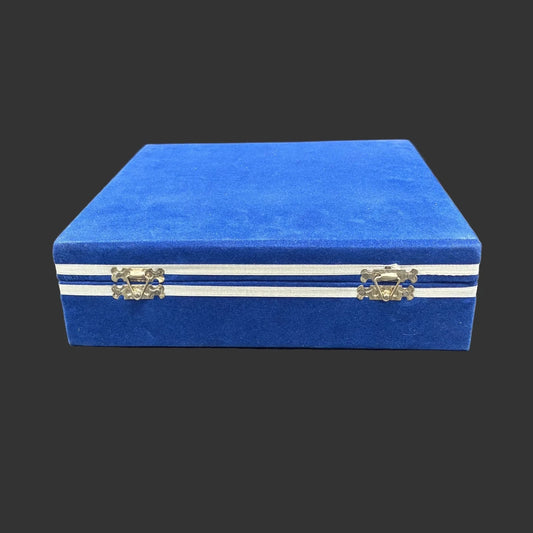 Blue velvet case that is included with the set of 6 sherry glasses, in front of a black background.